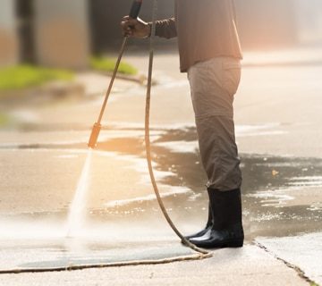 Man Using High Pressure Washer on the Driveway — Pressure Washers in Townsville, QLD