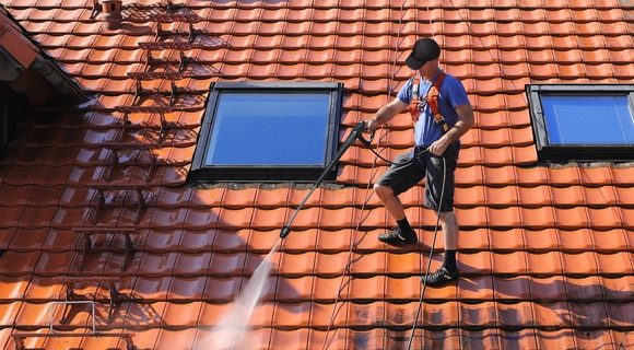 Man Uses Pressure Washer on Roof — Pressure Washers in Cairns, QLD